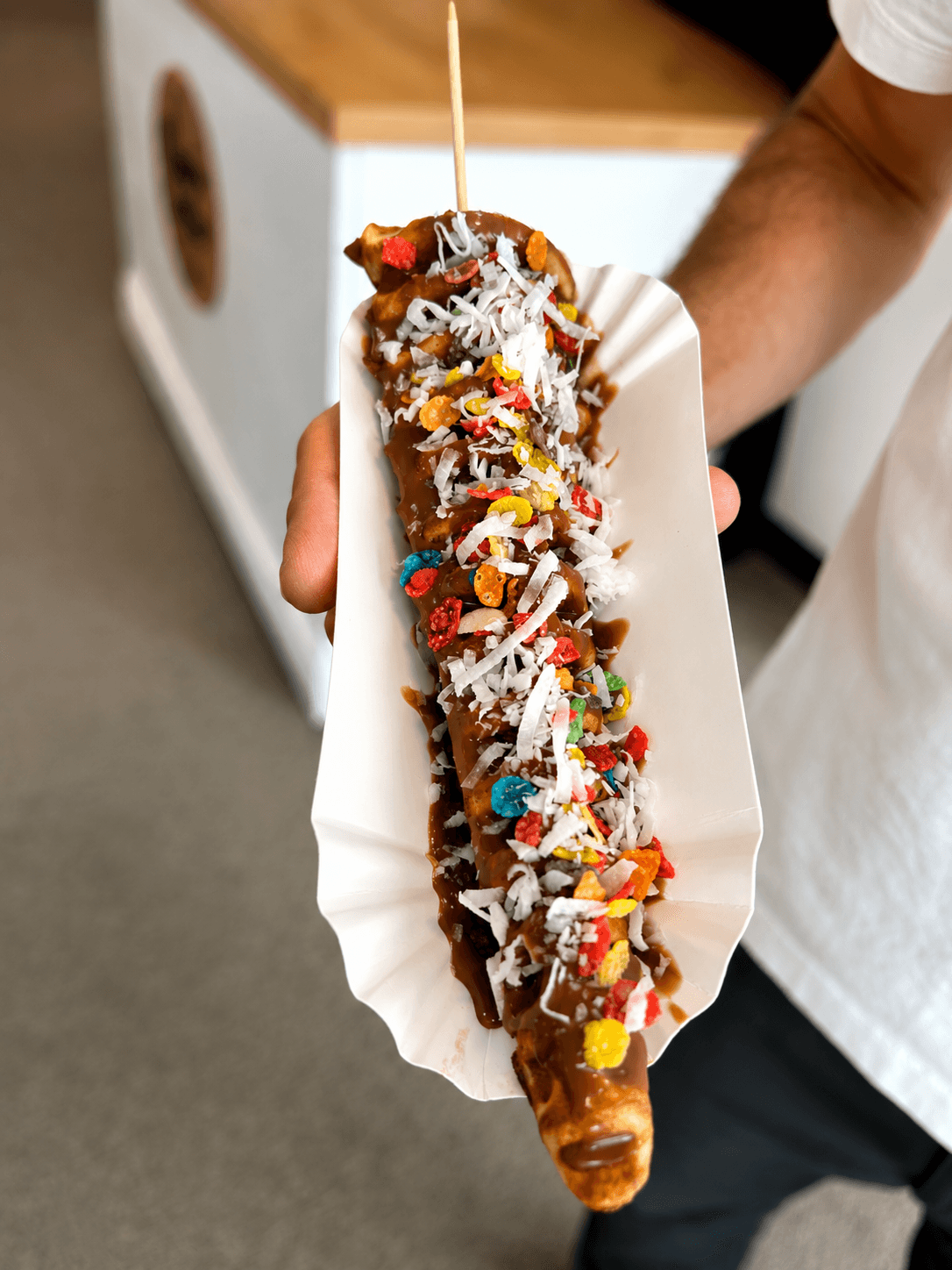 Stick waffle topped with fresh fruit, chocolate, and coconut from Wander Waffles CO